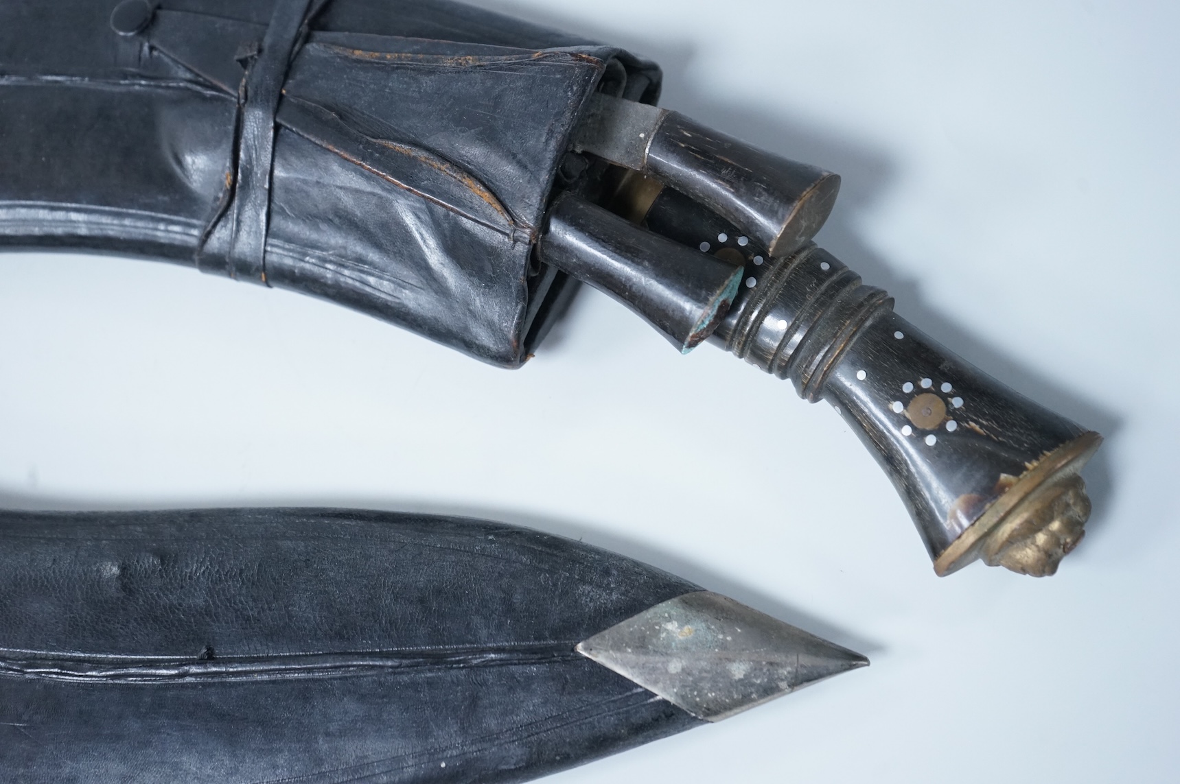 Two kukri knives in leather covered scabbards